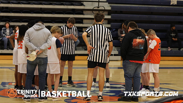 Trinity Sports youth basketball league in Texarkana. Teams gather in a circle to pray before the start of their game.