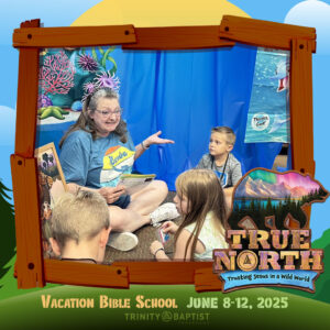 A group of kids listens to a Bible Story during vacation bible school in Texarkana. Photo has wooden photo frame around it and the logo for True North VBS.