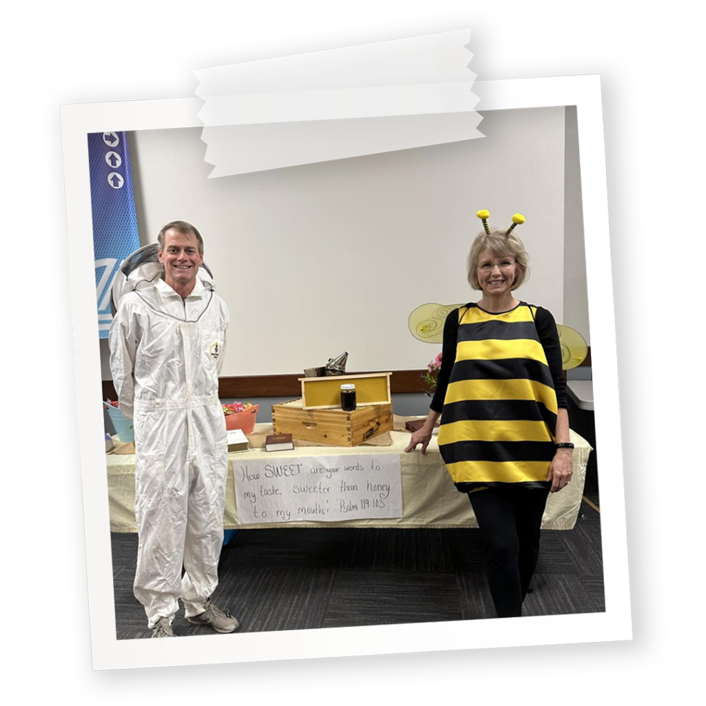 A church trunk-or-treat booth for Psalm 119 featuring a beekeeper and a bee with the bible verse written on it.